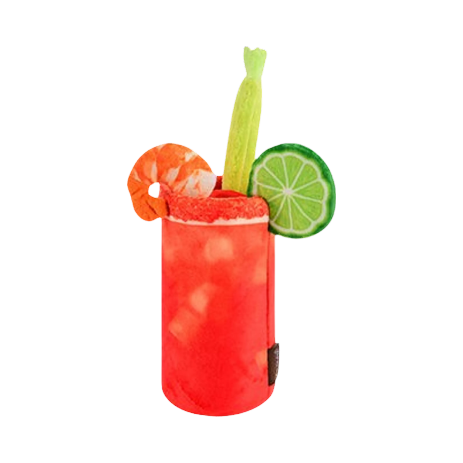 Verre rouge garni d'une crevette, d'un citron vert et de céleri
