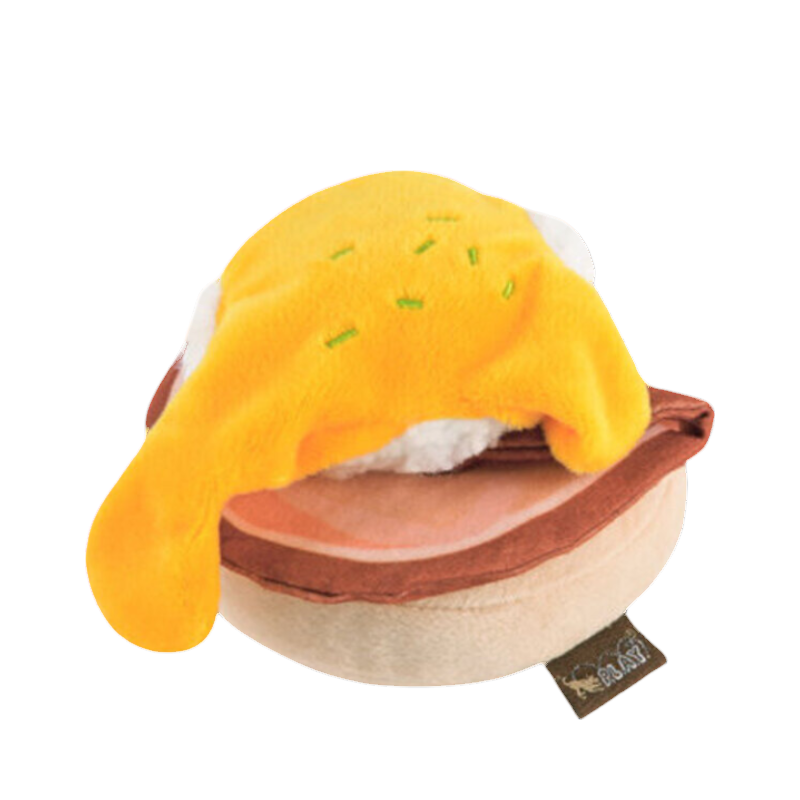 Muffin beige nappé d'une sauce hollandaise jaune, vu de près