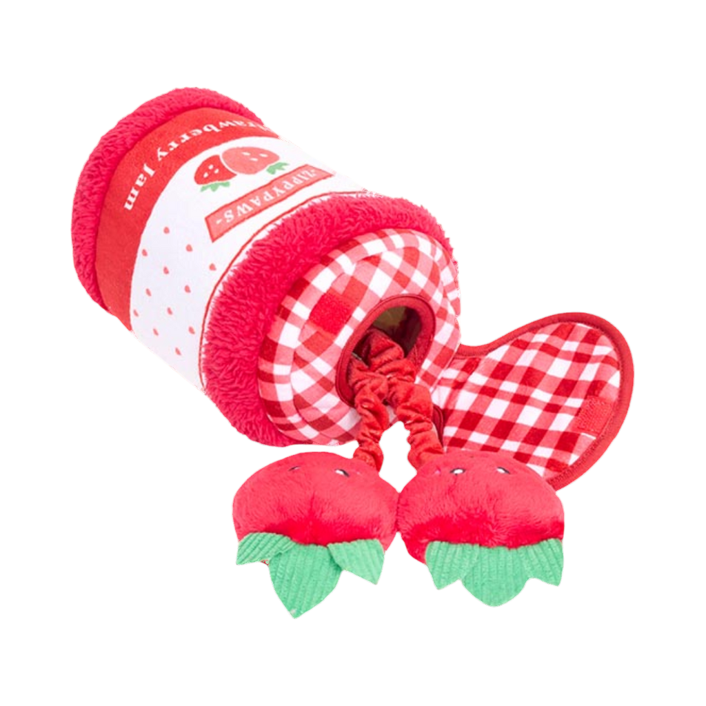 Deux fraises souriantes jaillissant du pot rouge