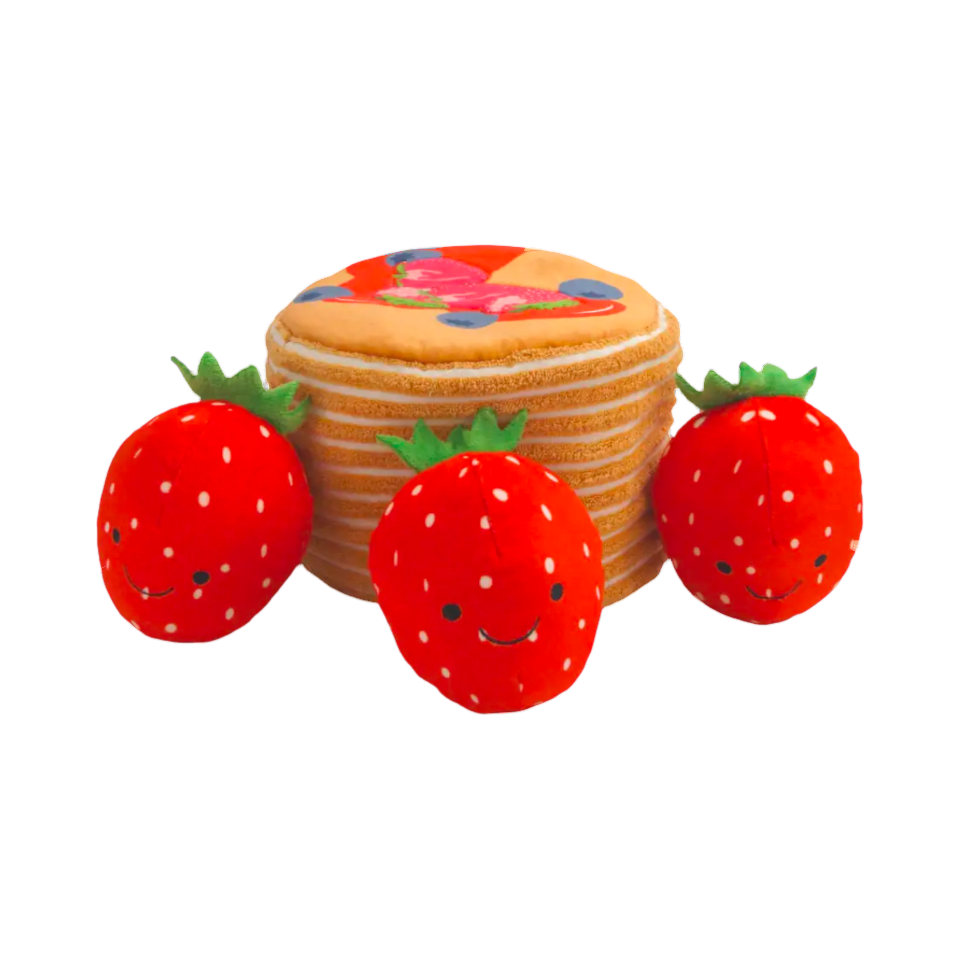 Pile de pancakes dorés avec son trou pour cacher les fraises