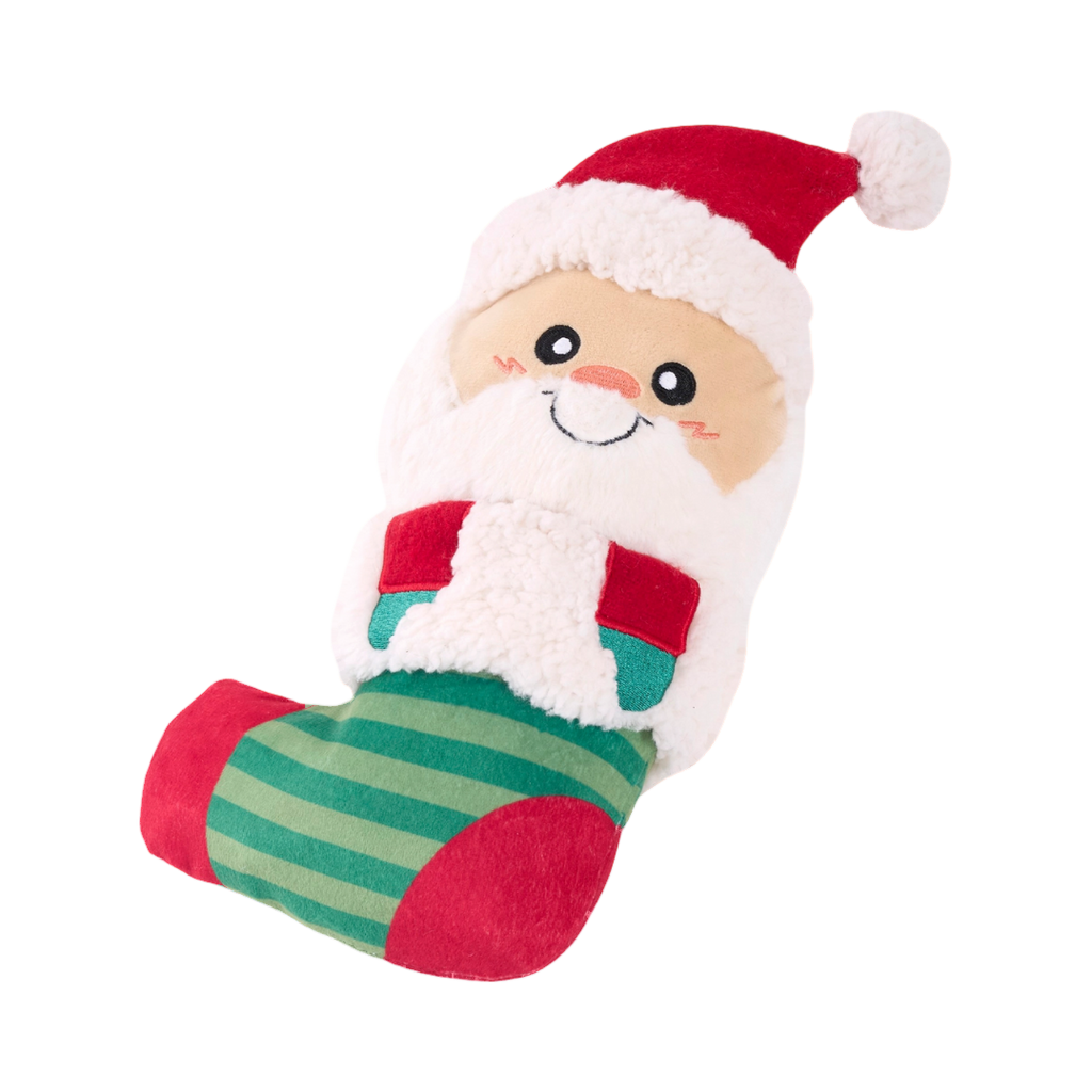 Père Noël souriant en peluche dans une chaussette rayée verte