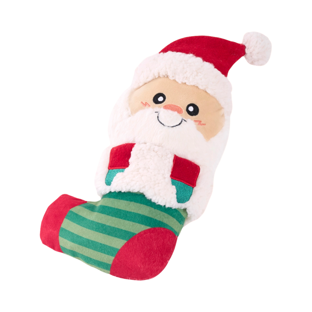 Père Noël souriant en peluche dans une chaussette rayée verte